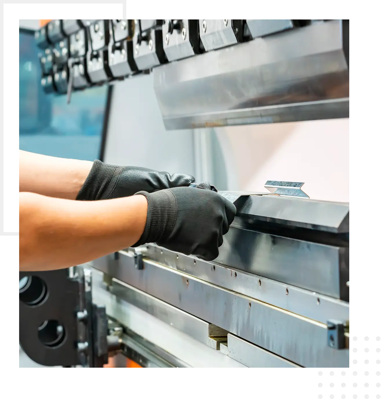Gloved hands adjusting metal sheet on press